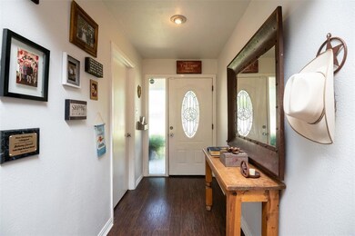 Entry way. Door leads to large utility room with f