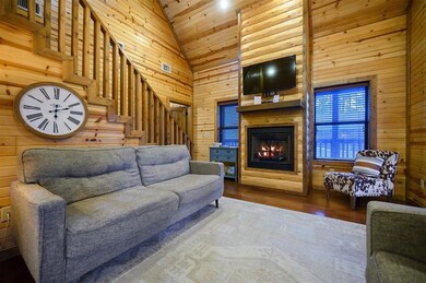 Living room featuring hardwood / wood-style flooring, high vaulted ceiling, wood ceiling, and wooden walls