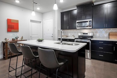 Kitchen featuring backsplash, a center island with