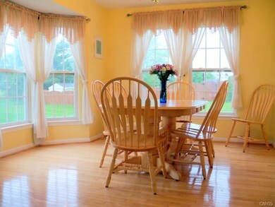 Formal dining room with hardwood floors and an abu