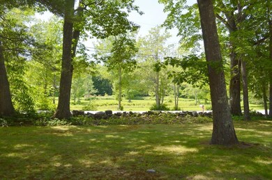 Front yard and view of meadow across...