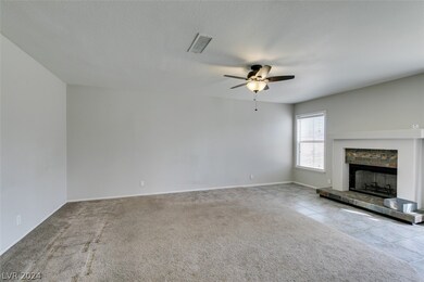 Large family room with fireplace and ceiling fan &
