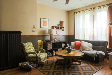 Living room offers soaring 9-foot ceilings, chair 