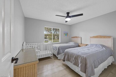 Bedroom with a ceiling fan, a textured ceiling, an
