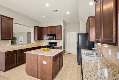 This kitchen has so many cabinets and drawers for storage!