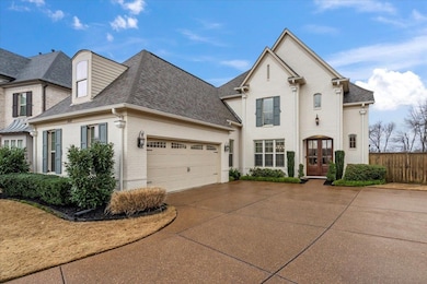 View of front of home with a garage and french doo
