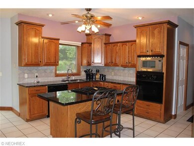 This kitchen has stunning granite counters, tile b