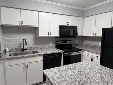 Kitchen with decorative backsplash, crown molding,