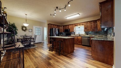 This Chef's Kitchen is freshly remodeled and extremely spacious.  The Luxury Vinyl Plank flooring, Granite counters, and ample cabinetry shine, and the Stone Backsplash needs to be seen in person!