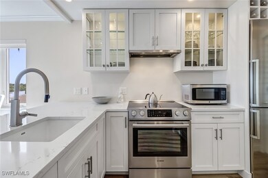 Kitchen featuring sink, light stone countertops, o