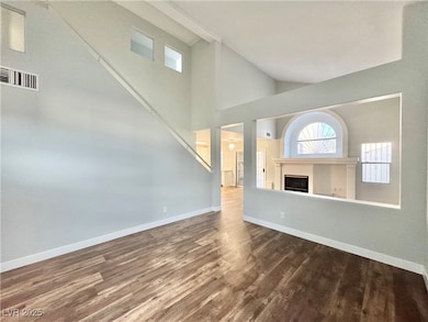 Unfurnished living room featuring a fireplace, woo