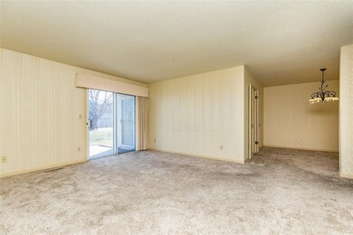 View of living room and into dining room. Sliders 