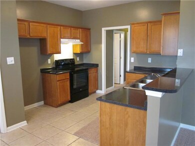 This spacious kitchen has plenty of cabinets and c