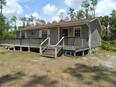 View of front of house featuring a wooden deck