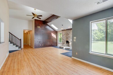 Unfurnished living room with a stone fireplace, li