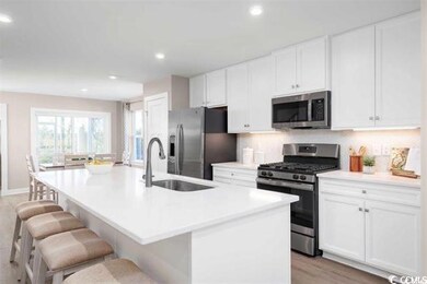 Kitchen featuring a breakfast bar, light hardwood 