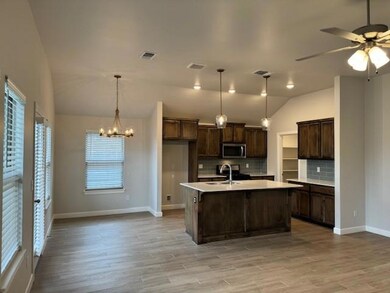 Kitchen with decorative light fixtures, a center i