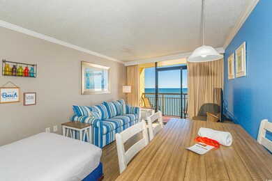 Dining room with a textured ceiling, a water view,