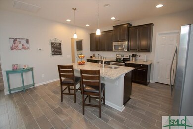 Large granite center island with breakfast bar.