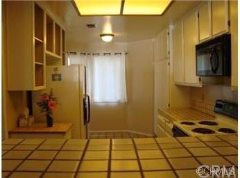 View of kitchen from dining room pass through