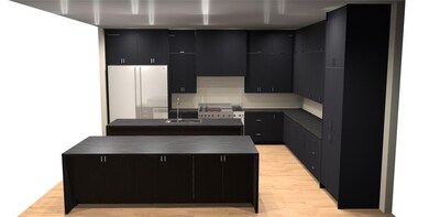Kitchen with dark countertops, a center island, a sink, freestanding refrigerator, and dark cabinetry
