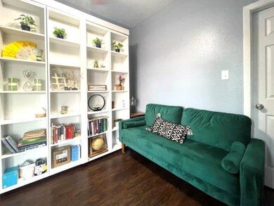 Sitting room featuring wood finished floors and a