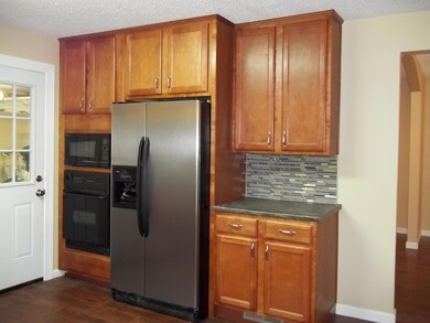 Open kitchen has Legacy Cabinetry