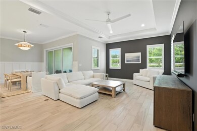 Living room featuring light wood-style floors, a t