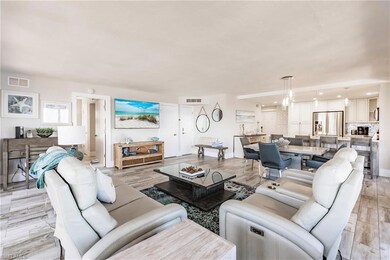 Living room with a chandelier and light hardwood /