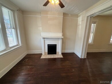 Unfurnished living room featuring dark wood-type f