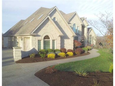 Exterior Front. Exposed aggregate driveway and mea