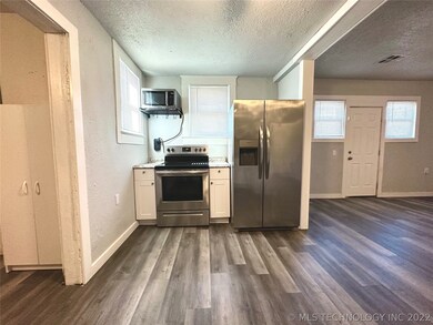 The kitchen features stove, microwave and refriger