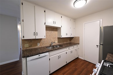 Kitchen with dishwasher, freestanding refrigerato
