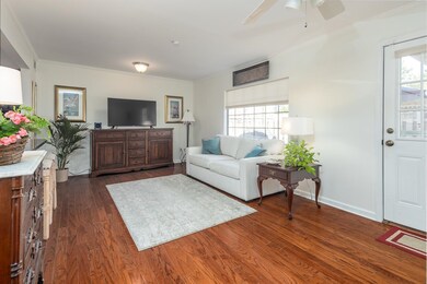 Living room featuring crown molding, ceiling fan, 