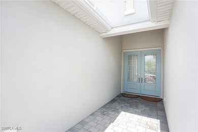 Entrance to property with stucco siding and french