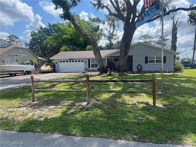 Ranch-style house with asphalt driveway and an att