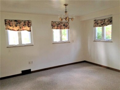 This spacious dining room with 3 windows allows so