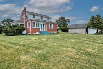 Rear & Side View of home + Garage & Shed