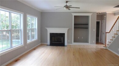 Great Room with fireplace, lighted ceiling fan.