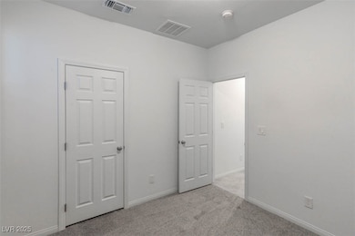 Unfurnished bedroom featuring light colored carpet and baseboards