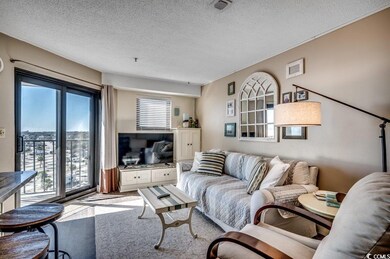 Living room featuring a textured ceiling and hardw