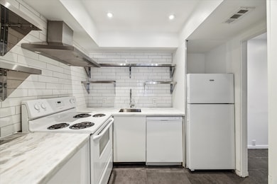 Kitchen includes 4 coil range, vent hood, dishwash