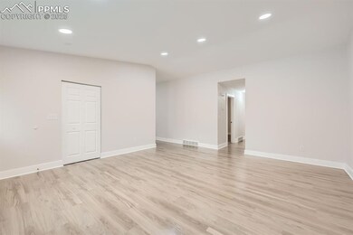 Unfurnished room featuring light wood-type flooring, recessed lighting, and baseboards