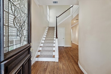 Solid hardwood floors and soaring ceilings greet y
