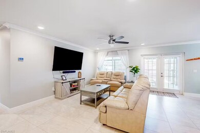 Tiled living room featuring ornamental molding, ce
