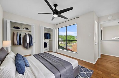 Bedroom featuring multiple closets, wood finished