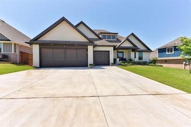 Craftsman inspired home with concrete driveway, an attached garage, roof with shingles, brick siding, and board and batten siding