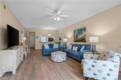 Living room with baseboards, visible vents, a ceil