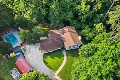 Aerial view of property and surrounding area with a pool area