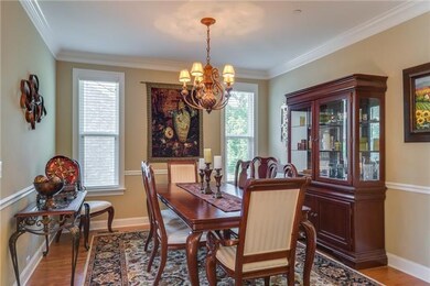 Formal Dining Room with upgraded chandelier! Great trim work and wood floors to make any occasion special! 